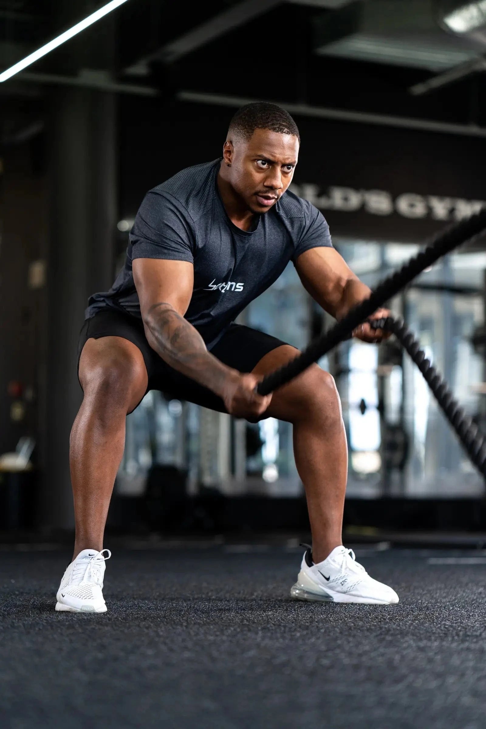 athlete wearing botthms black sport t-shirt during workout