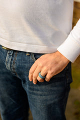 man wearing grey silicone ring in his left hand finger