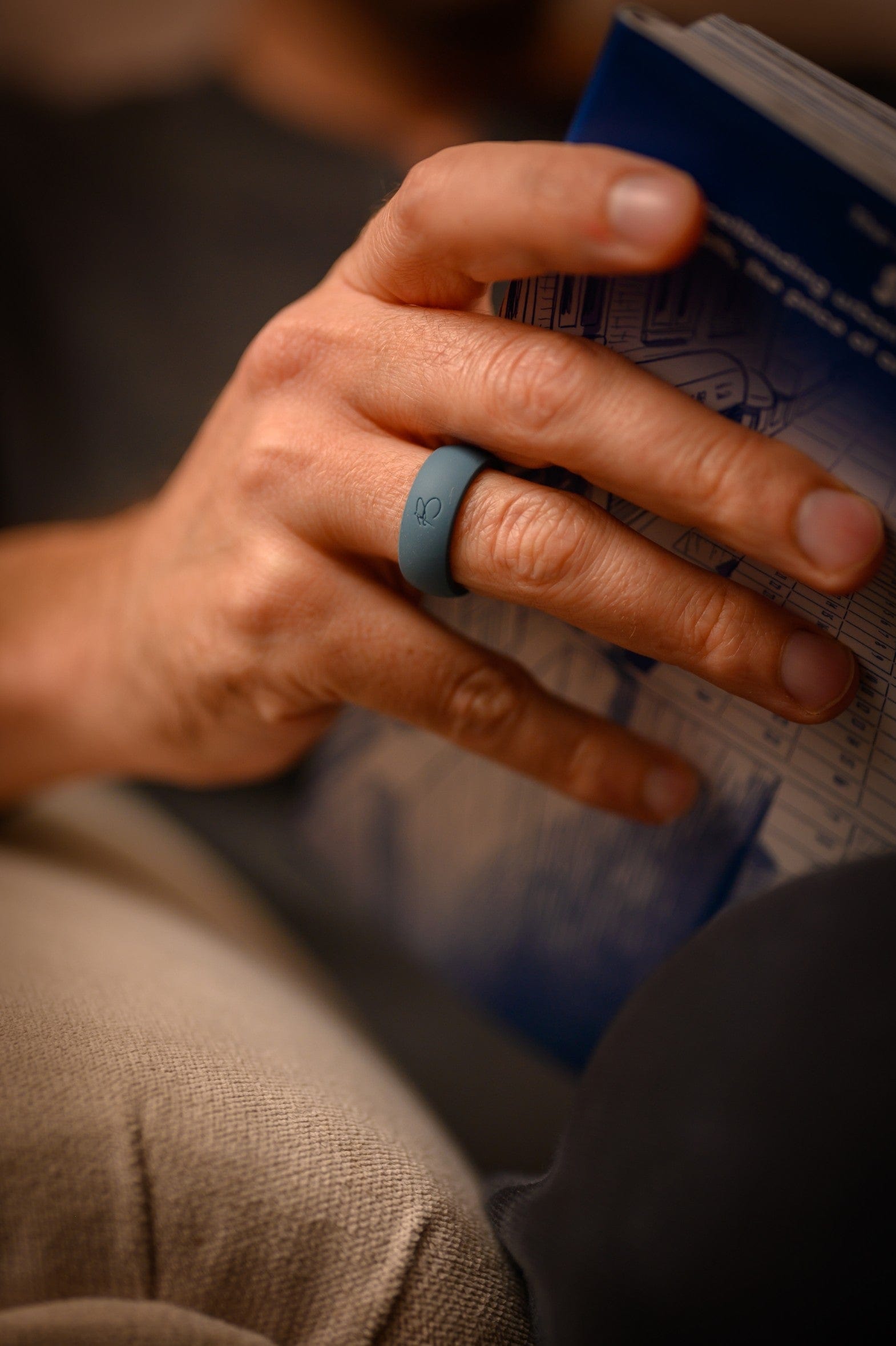 a hand wearing botthms silicone ring